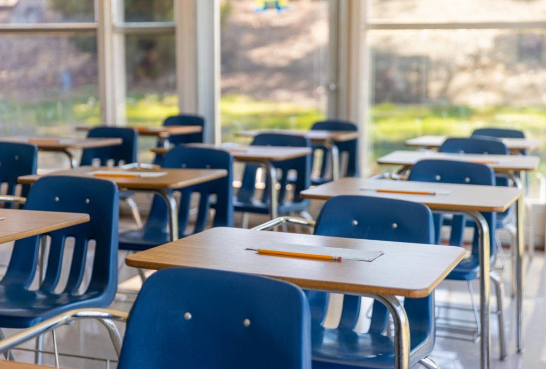 Student raising a hand in a classroom