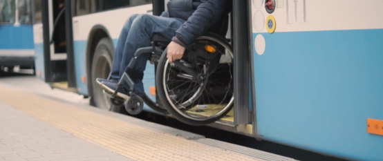 Screenshot from Amy Hogan video showing wheelchair user coming out of a bus door sml