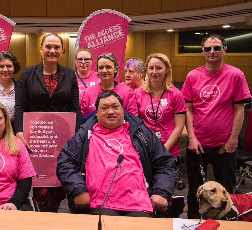 Access Matters volunteers in pink branded tshirts with NZ Parliamentarians -photo Victor Komarovsky-smcrp3