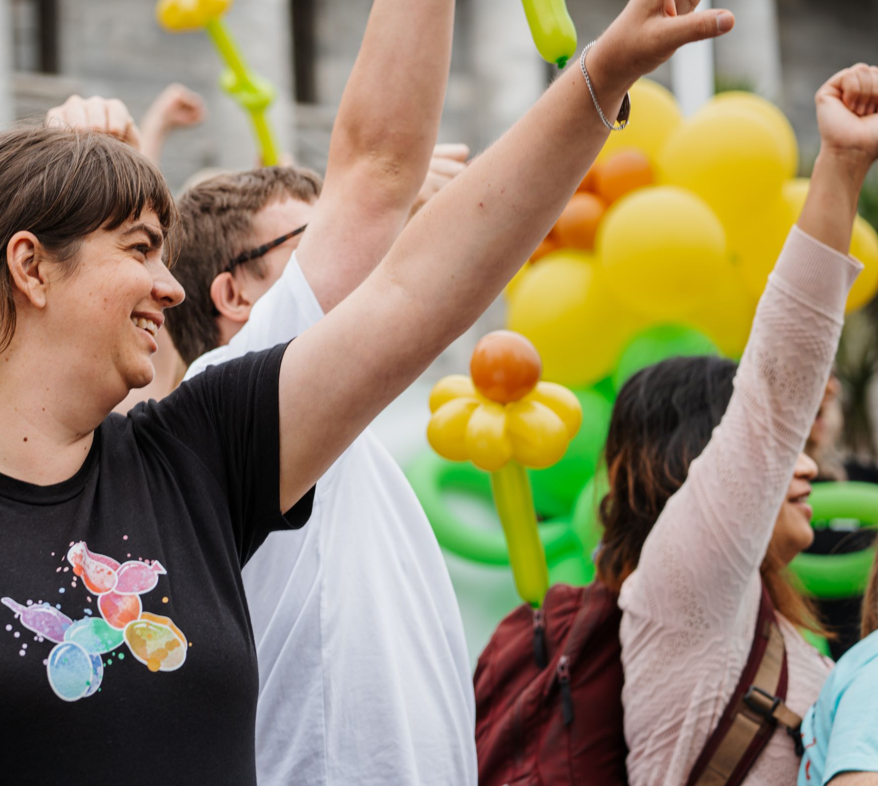 Access Matters Campaigners with hands in the air and sunflower balloons
