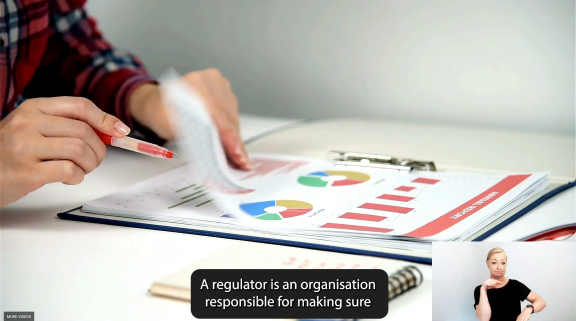 Screenshot from Amy Hogan video showing a person checking a written report  pen in hand crop sml