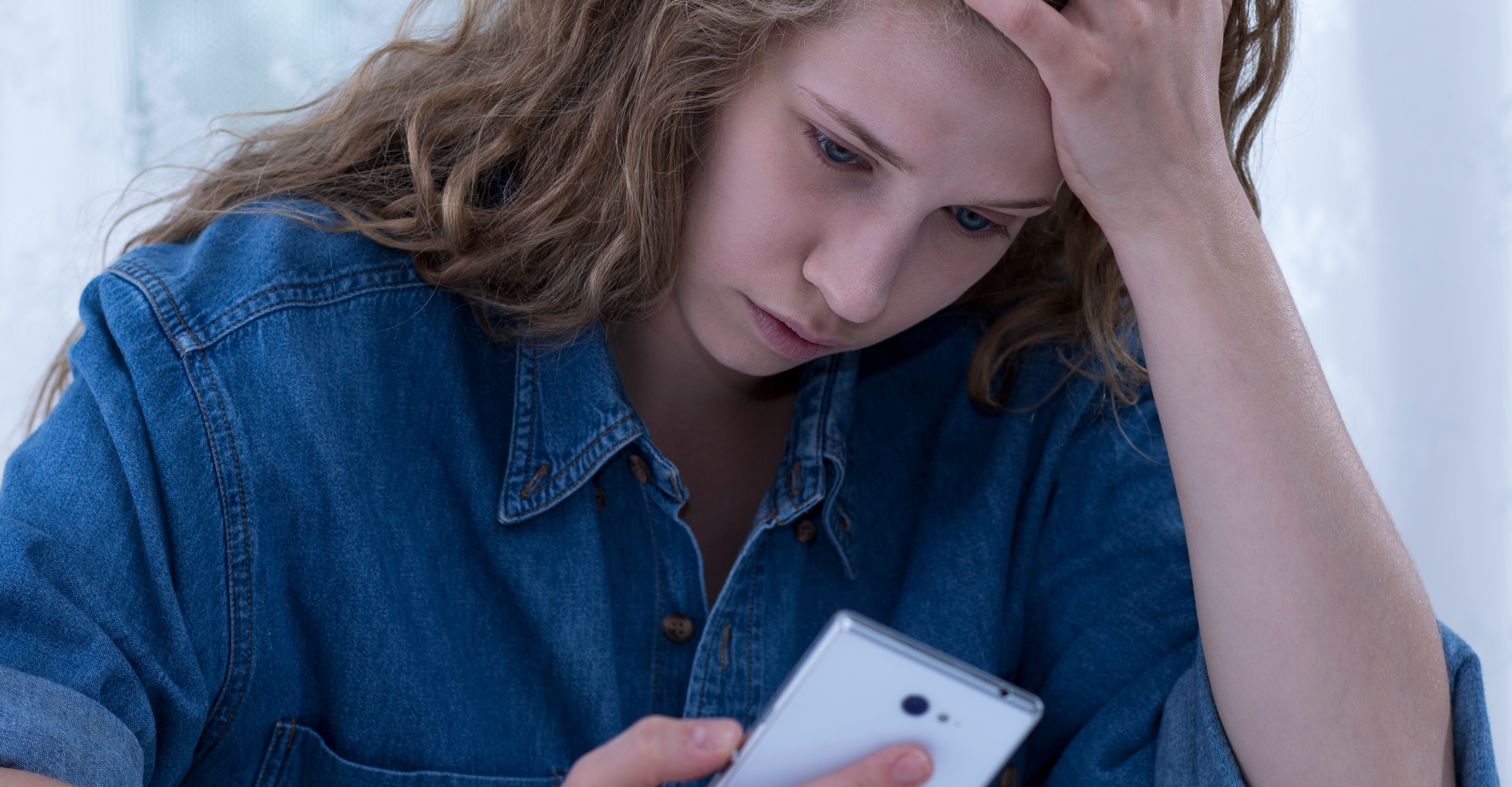 Woman stressing out looking at phone