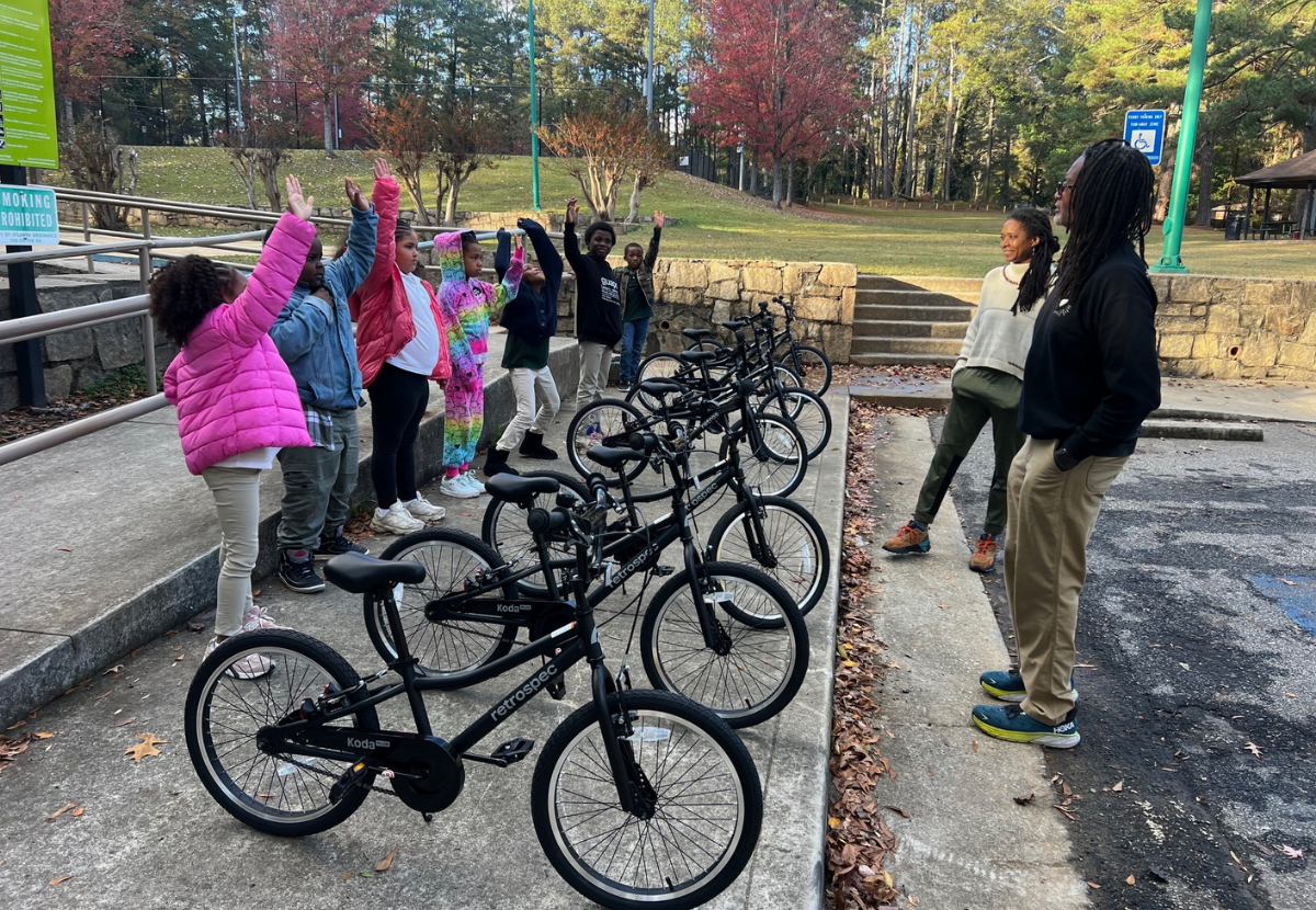 Instructor helping kid with helmet