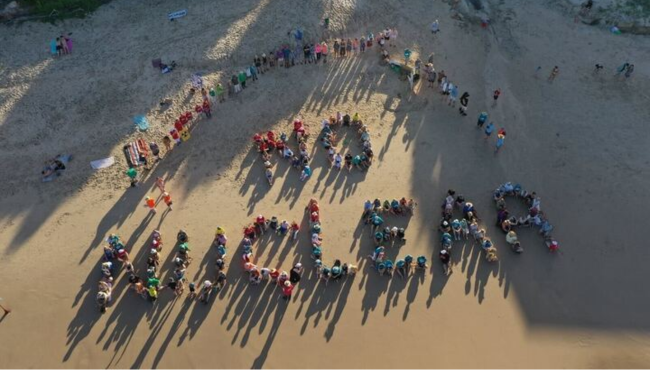 Human 'no nuclear' sign on beach