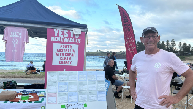 Man collecting vote pledges at beach.