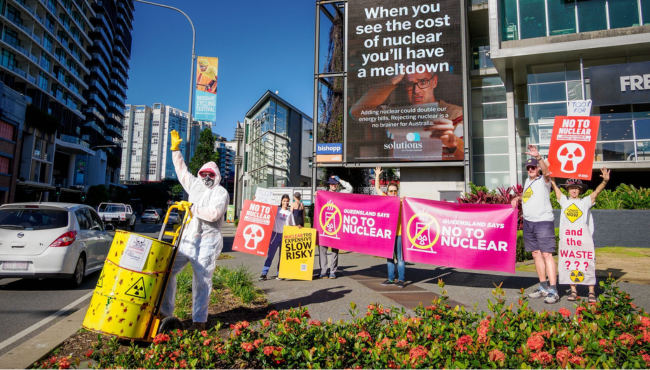Volunteers hold anti-nuclear protest in hazmat suits with radioactive barrels on promiment roadside