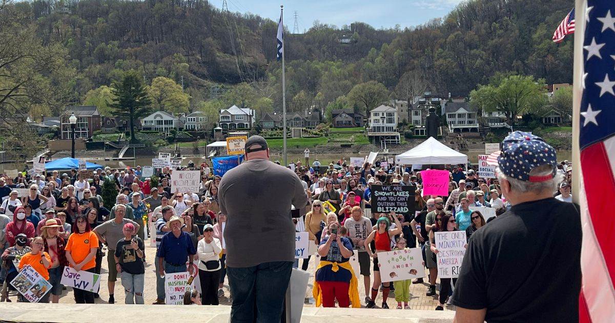 Zach Shrewsbury speaking at a rally with a big crowd