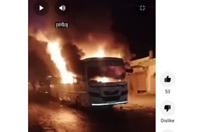 A bus burns, reportedly in retribution carried out by locals for the deaths of two people on the truck-congested roads.