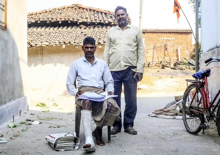 Arun (sitting), the keeper of the register against all the cases against the villagers, and ‘Vikas’ (right) who has been targeted the most by the police and the company. Image by the author