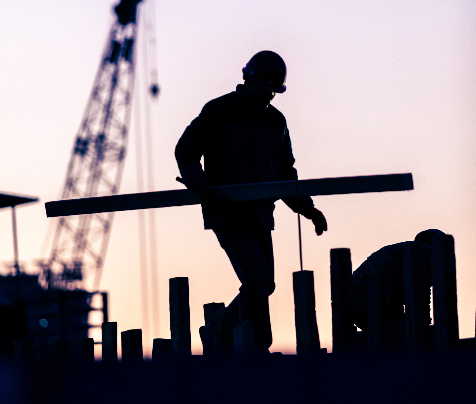 Silhouette of builders working on a construction site