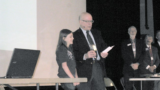 Randy_Sutter_and_a_young_volunteer_lead_National_Anthem.JPG