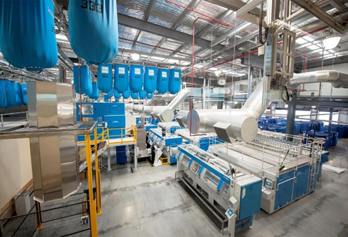 Image depicts a warehouse full of linens
