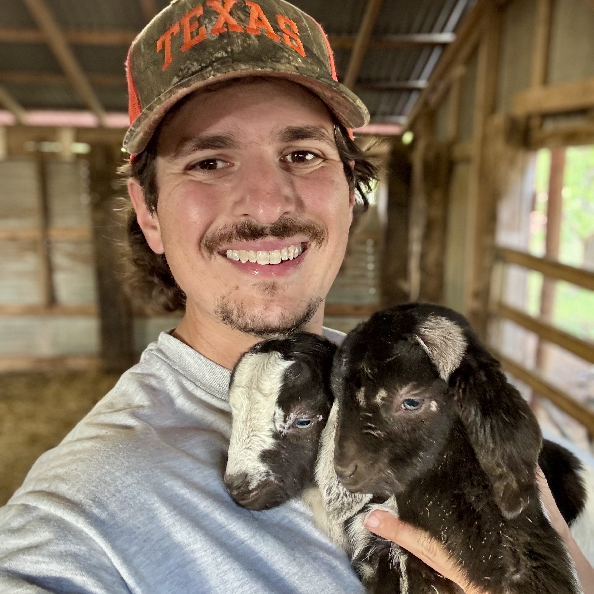 Clayton holding baby goats Clayton holding baby goats
