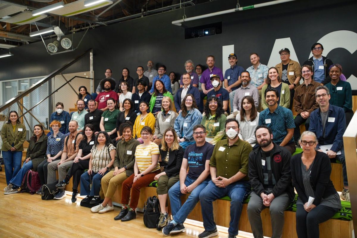 seated attendees smile for the camera