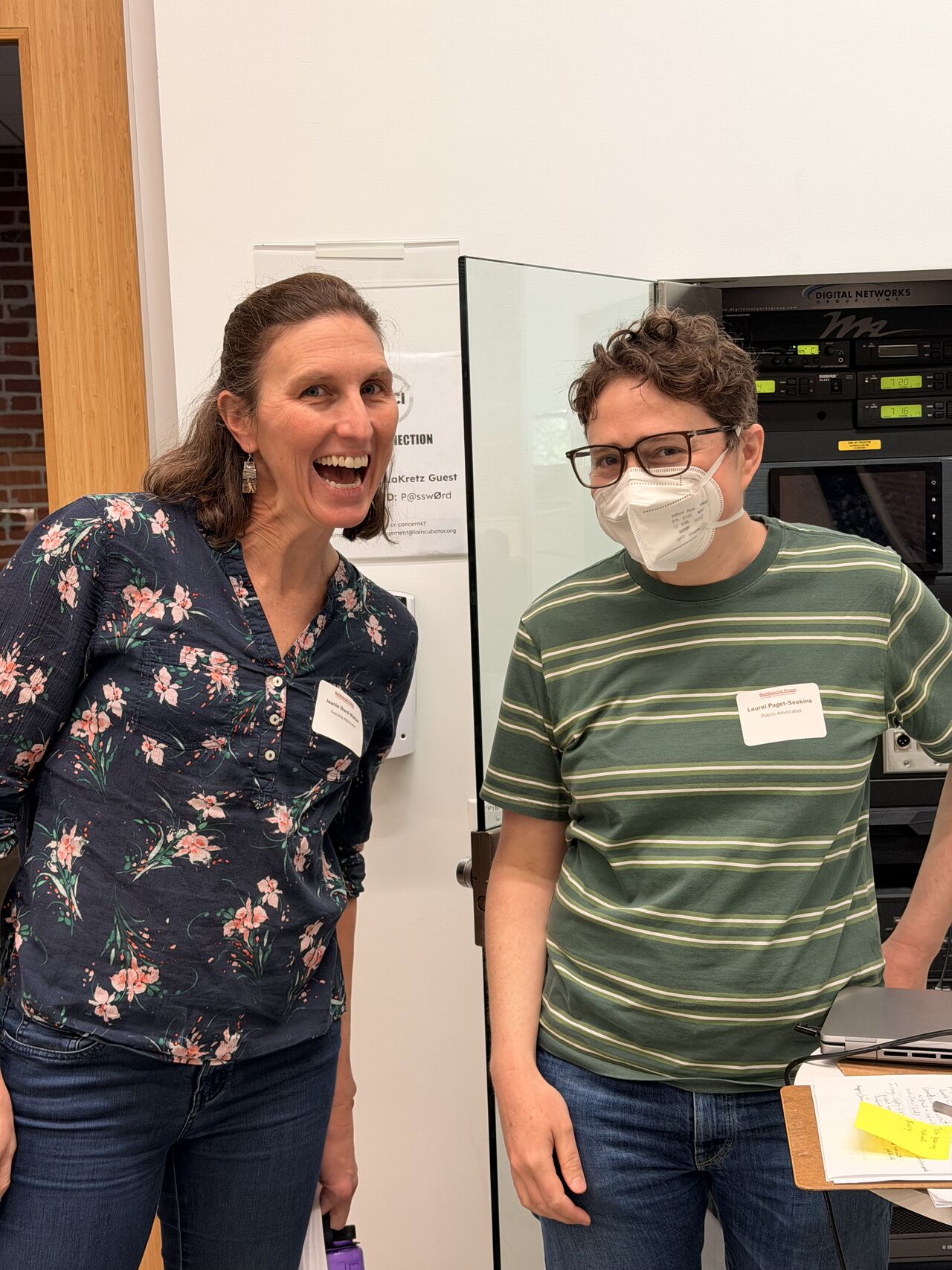 Two attendees standing and smiling 