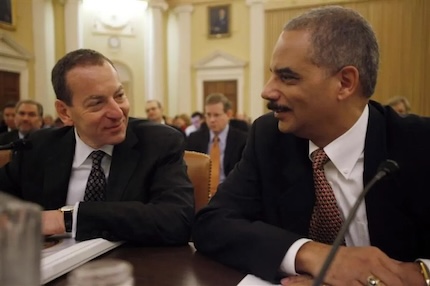 U.S. Attorney General Eric Holder (right) chats with Lanny Breuer