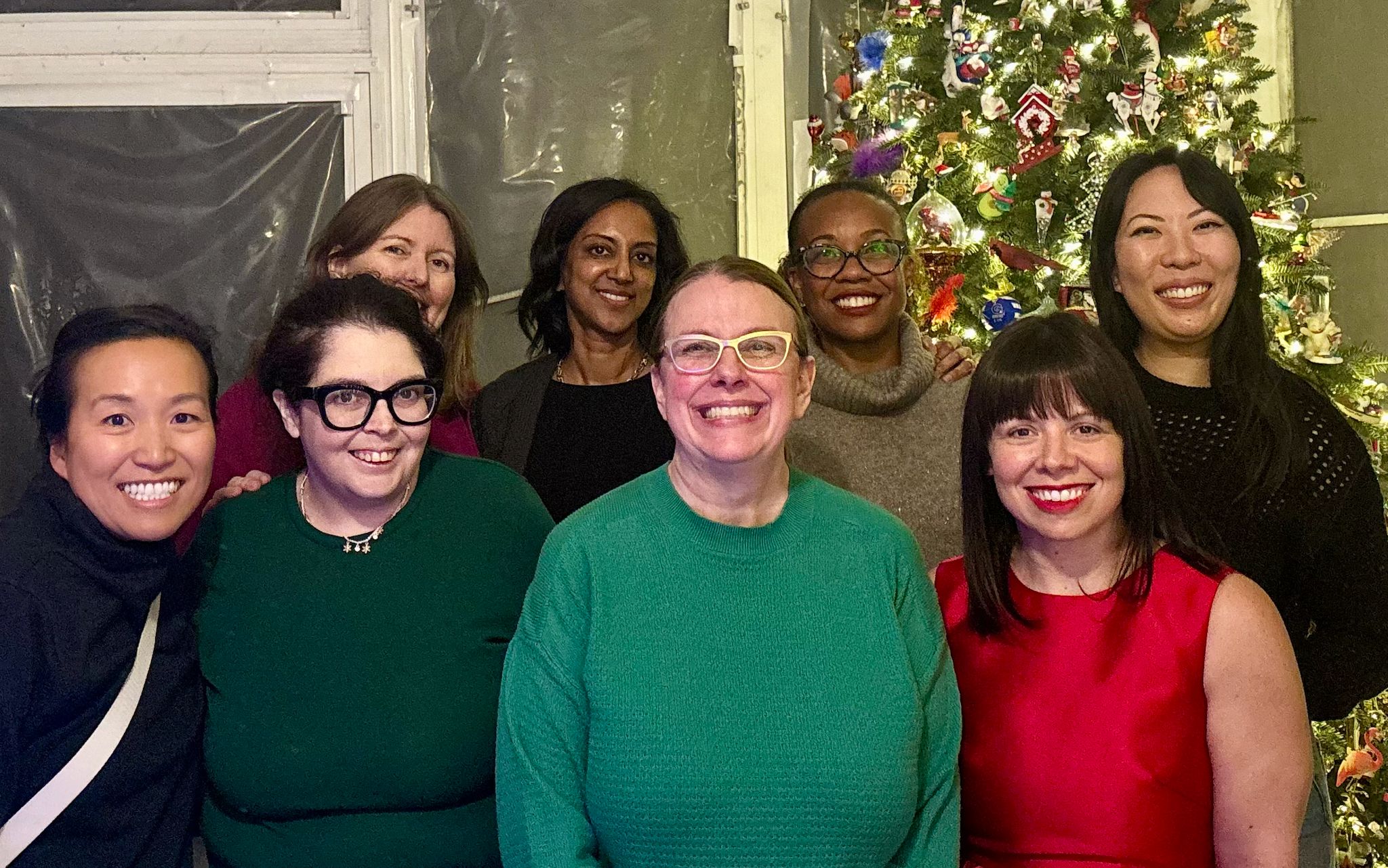 Former FCS members standing in front of a Christmas tree