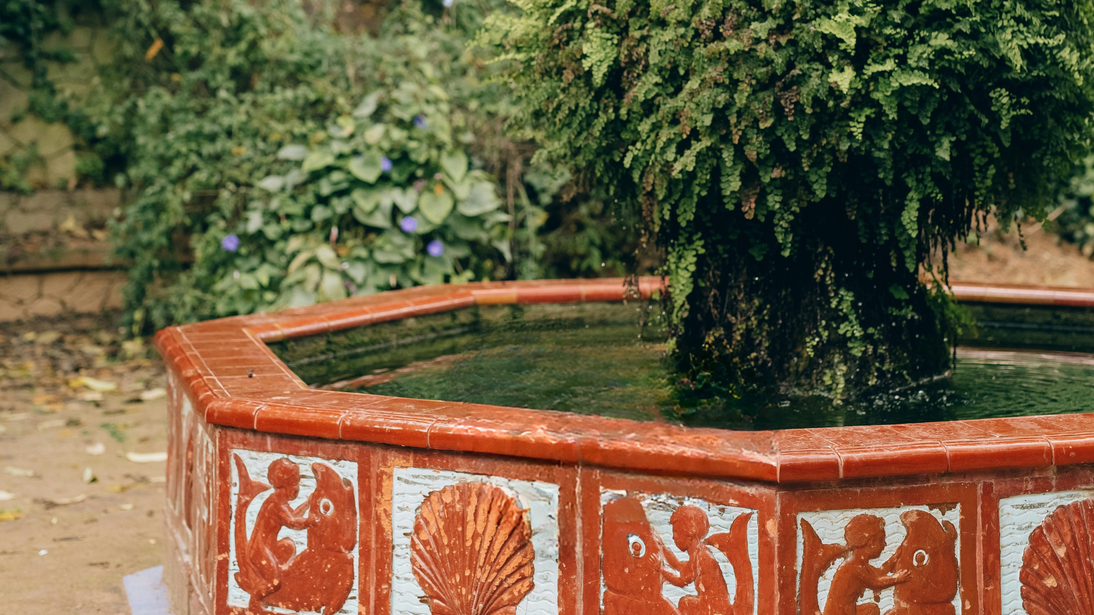 Red-tiled garden fountain as a shared source of water.
