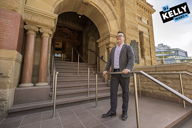 Img Alt: Cllr. Kelly stands outside of Calgary City Hall on May 28, 2026, following a marathon two-day council session that began on Tuesday morning. (Aryn Toombs / Ward 4)