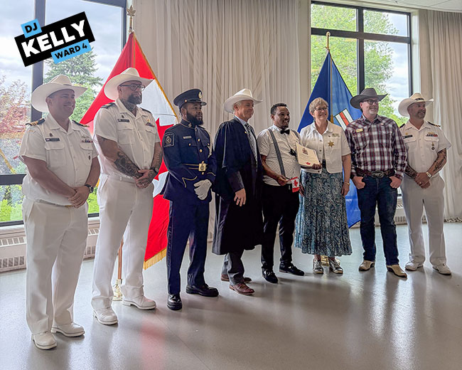Img Alt: Cllr. DJ Kelly poses for a photo with performance group Three Left Feet at Sein Lok Park on Canada Day. (Aryn Toombs / Ward 4)