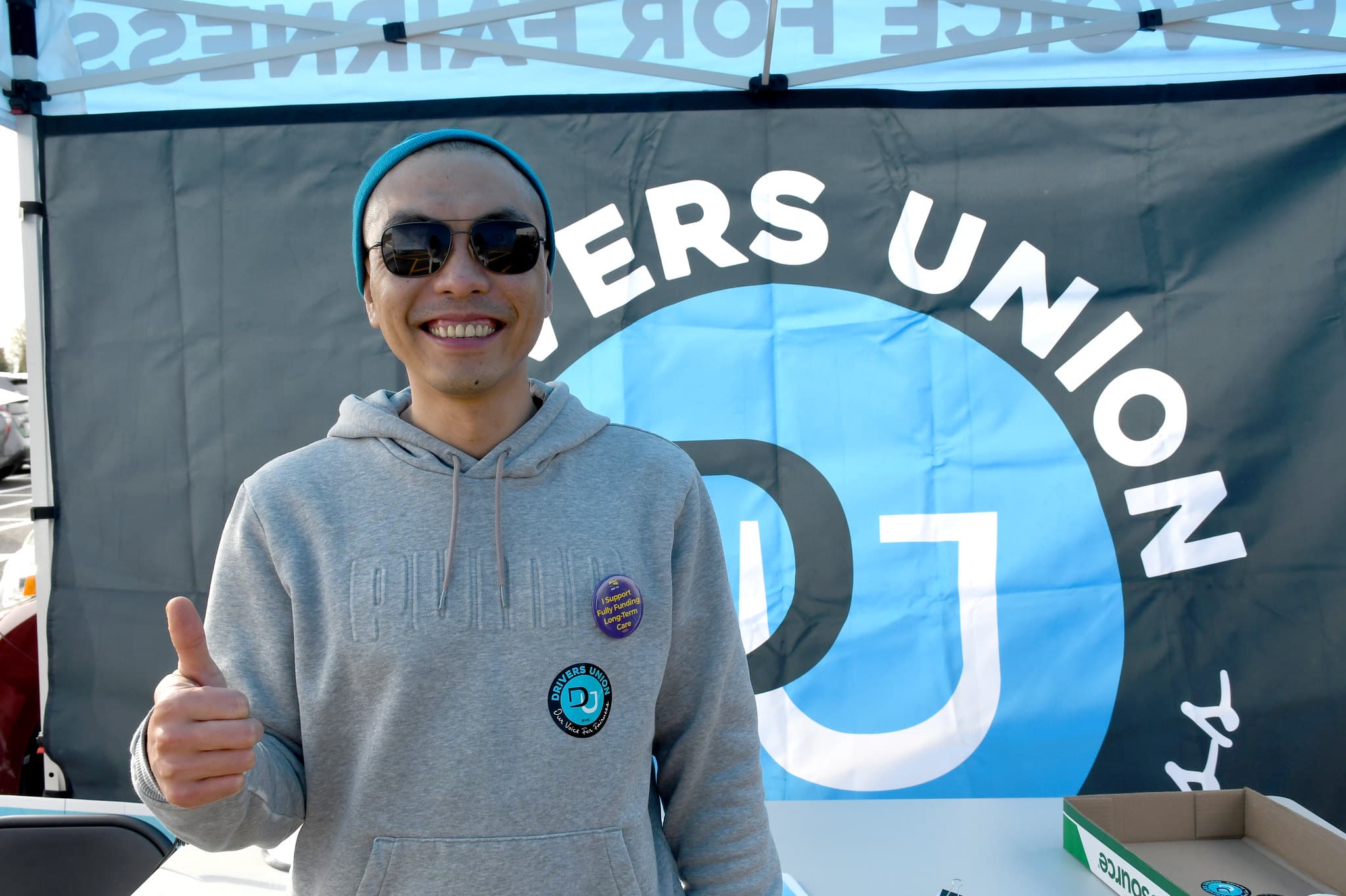Drivers union member in front of DU sign