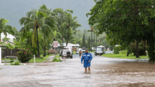 A man wades through flooded streets in Airlie Beach during ex-Tropical Cyclone Koji on Sunday morning. Photograph: Ingrid Hendriksen