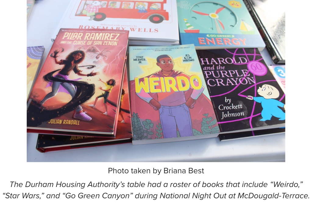 The Durham Housing Authority’s table had a roster of books that include “Weirdo,” “Star Wars,” and “Go Green Canyon” during National Night Out at McDougald-Terrace.