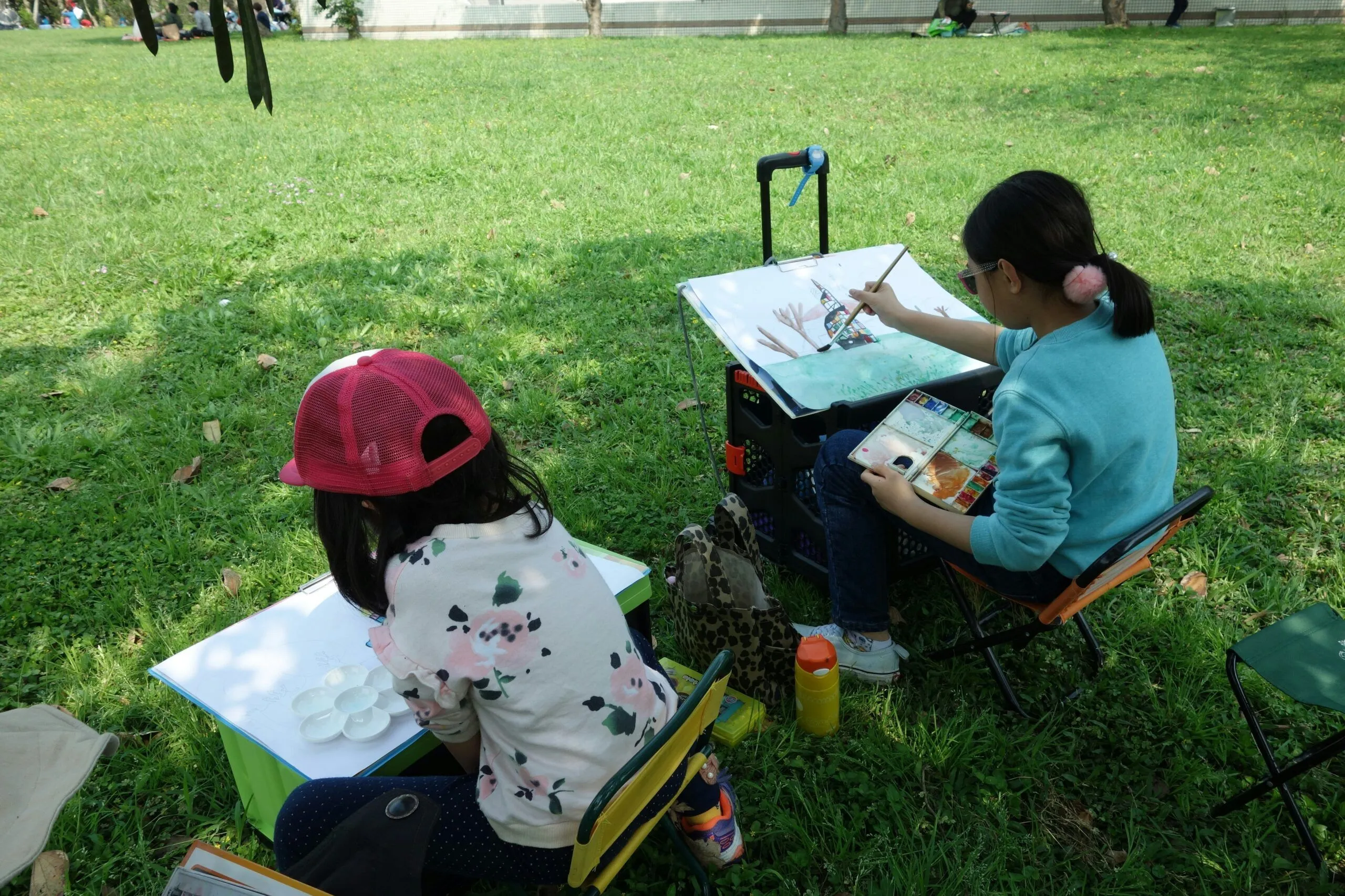 Children painting outside at a park
