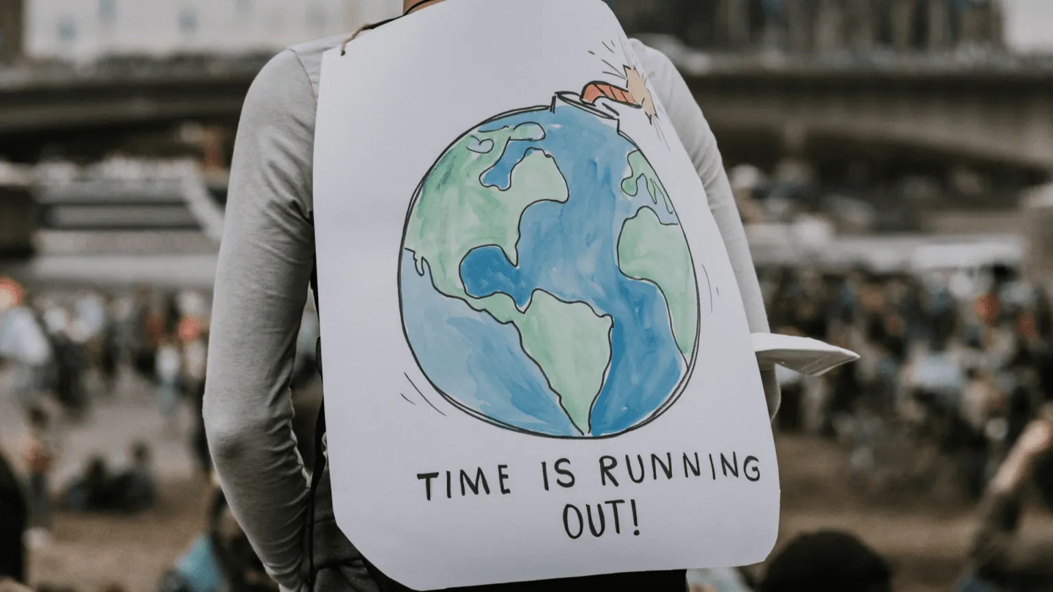 someone holding a "Time is Running Out"
banner
