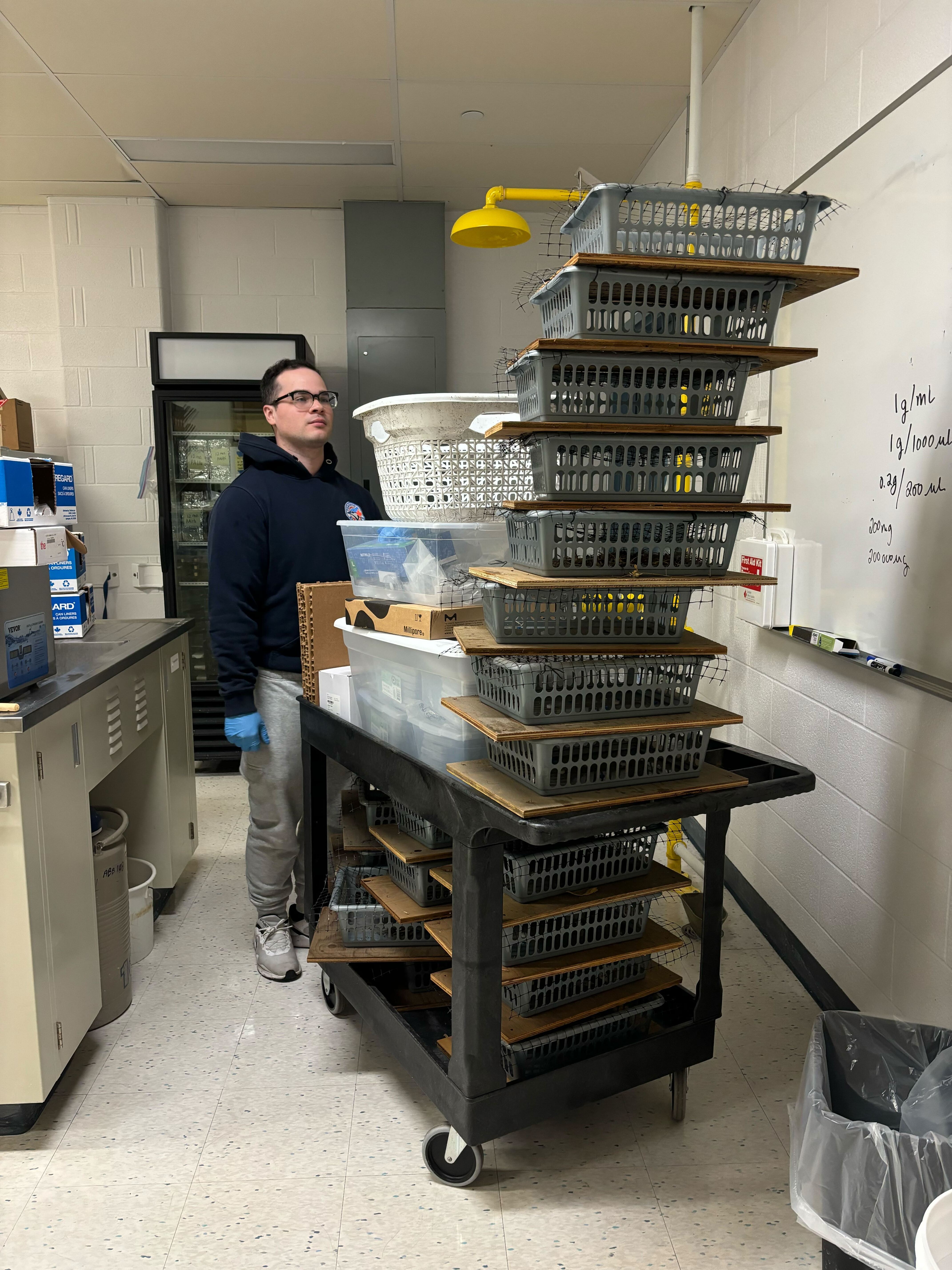 Victor Maldonado (PhD student and research team member) looks at a stack of collected sample kits.