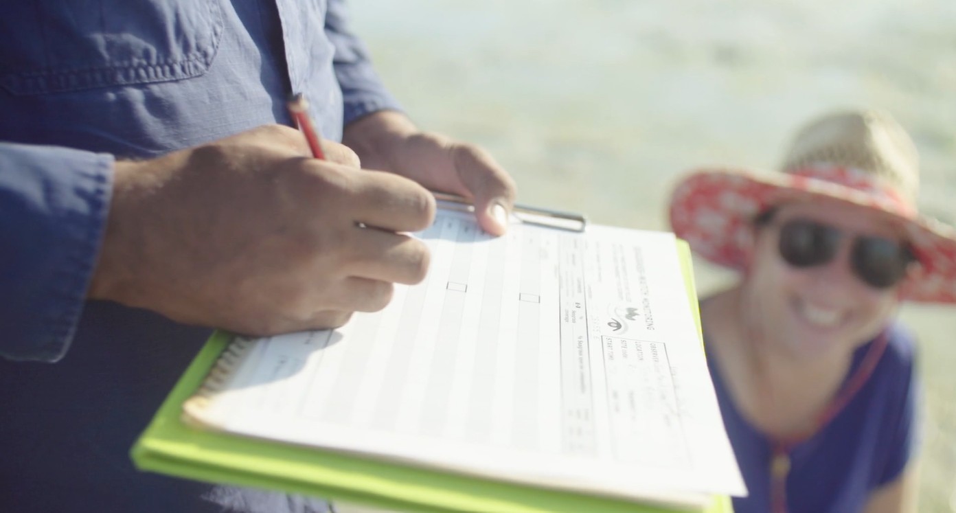 Seagrass-Watch data sheet and a smiling volunteer