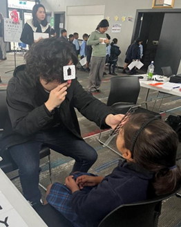 Child in classroom having eye examination