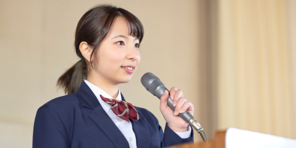asian woman speaking with microphone