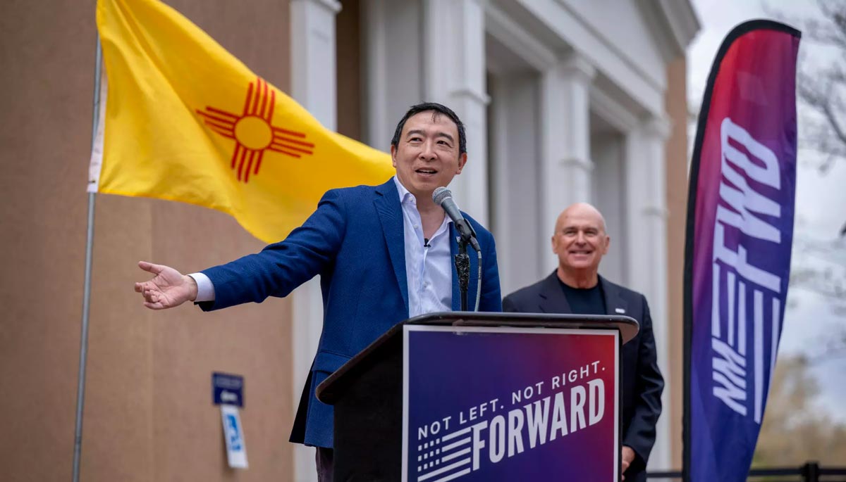 Andrew Yang at a podium speaking in NM