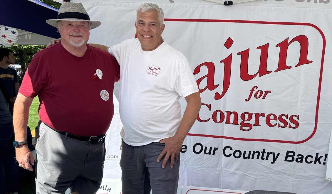 Congressional candidate Bajun Mavalwalla poses with a supporter in front of the Bajun for Congress campaign booth during the Union-Bulletin's 4th of July in the Park event at Pioneer Park in Walla Walla.