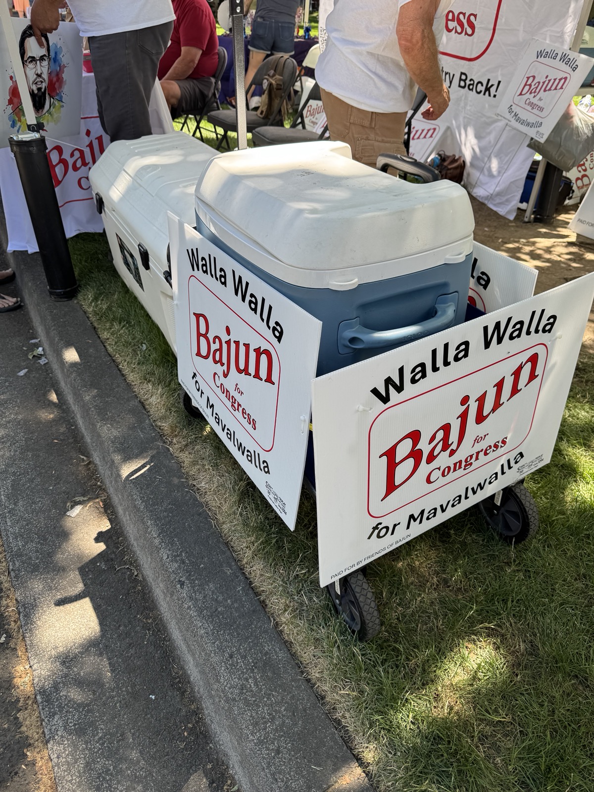 Campaign coolers and Walla Walla Bajun for Congress yard signs are displayed outside the campaign booth at the Union-Bulletin's 4th of July in the Park event in Pioneer Park.