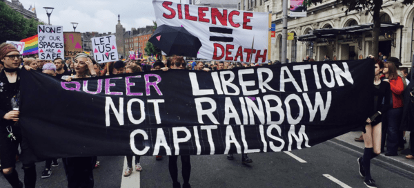 People Marching with Queer Liberation Banner