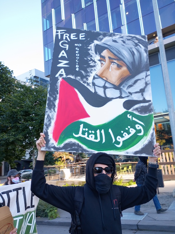 activist with painting Free Gaza