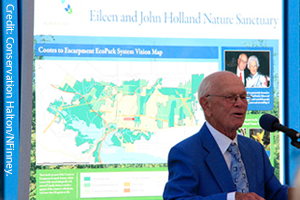 Photo of John Holland in front of Eileen and John Holland Nature Sanctuary. Photo by Nigel Finney.