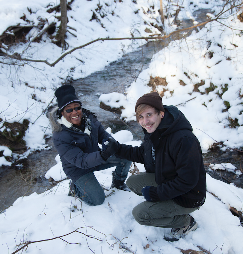 Janice and Nils pose beside a snowy stream in Orangeville
