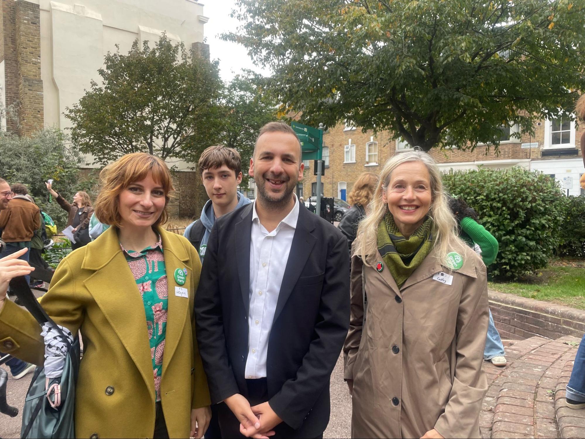 Ülgen Semerci and Cathy Troupp posing with Zack Polanski at the Green Party Big Day Out