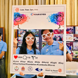 Image of 2 people behind a Love Your Eyes
Instagram Cut Out. 