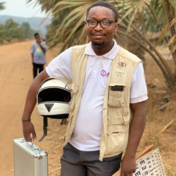 A man holding a briefcase smiles 