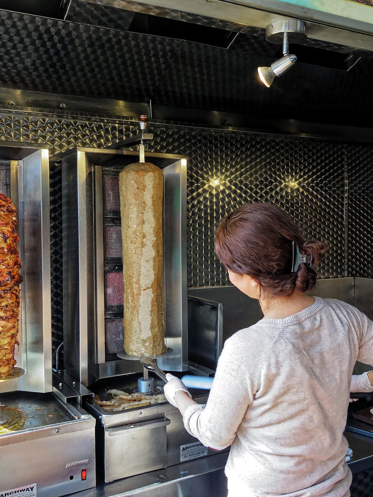 A lamb doner being sliced at a London kebab house