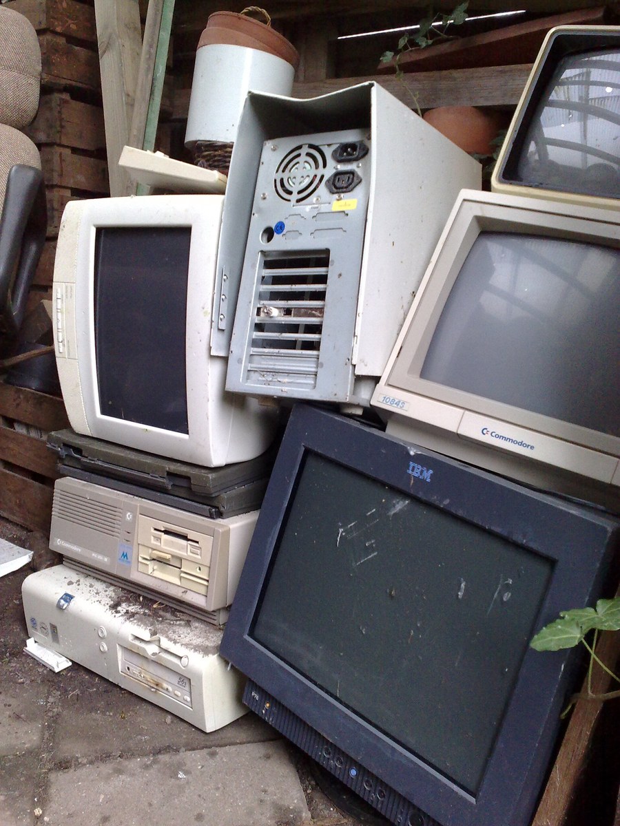 Old computers and monitors piled up ready for recycling