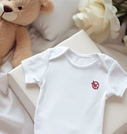 ICAN logo on baby onesie