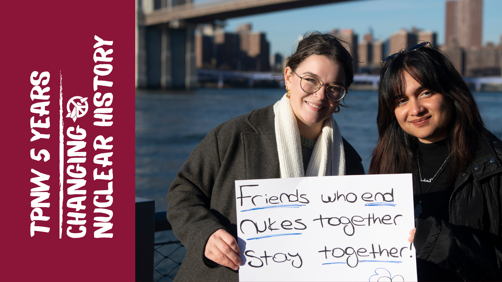Two campaigners holding a sign reading
'friends who end nukes together stay together!"