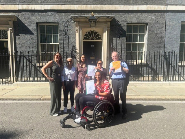 Photo of 6 staff and trustees from Inclusion Barnet holding our campaign letter outside of number 10 Downing Street.