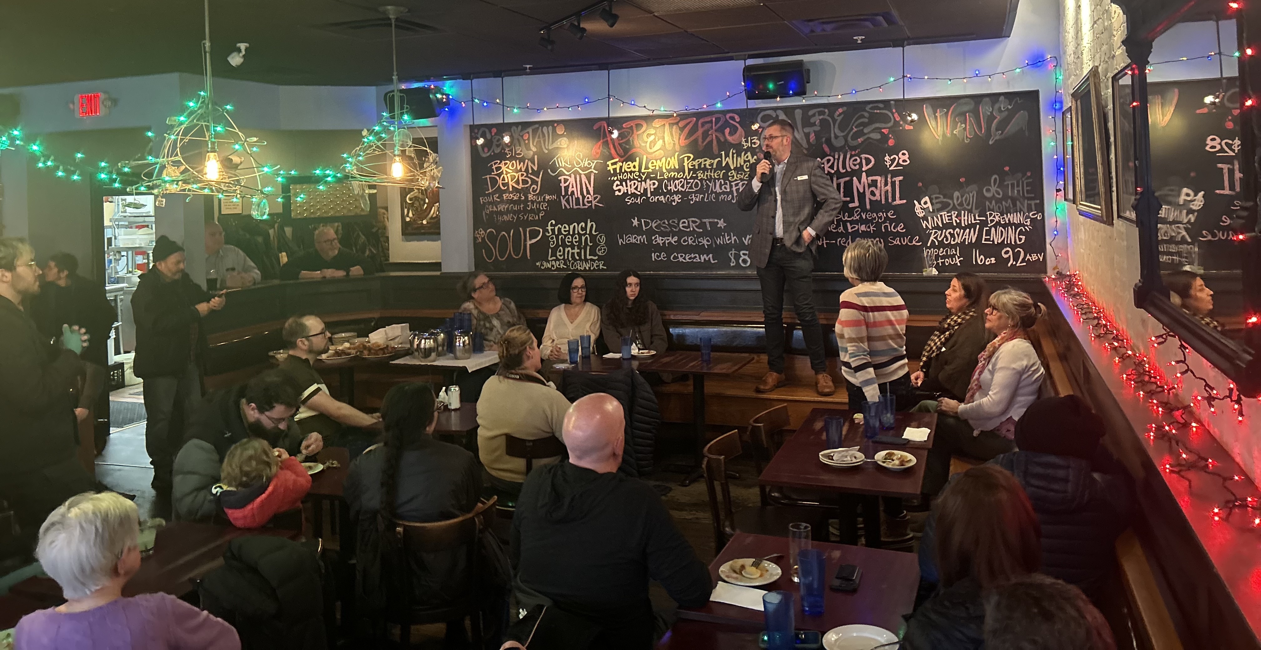 Jake standing in front of a crowd at Highland Kitchen