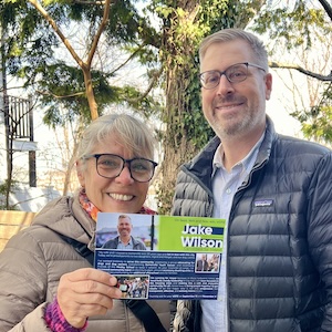Jake and Paula Jake and a volunteer pose with campaign literature